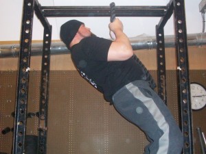 Man doing Narrow pull-ups in a gym.